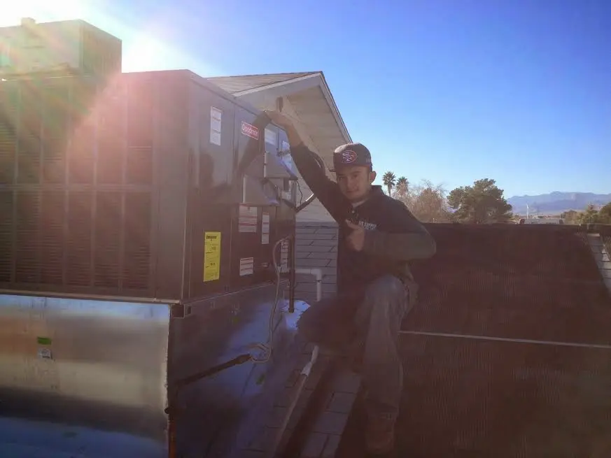 HVAC technician performing Heat Pump Repair on a rooftop unit in Villa Park